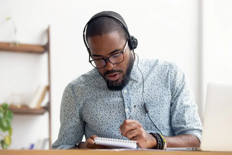 african american man headphones taking e learning course office sitting table black employee improving knowledge looking 149437791
